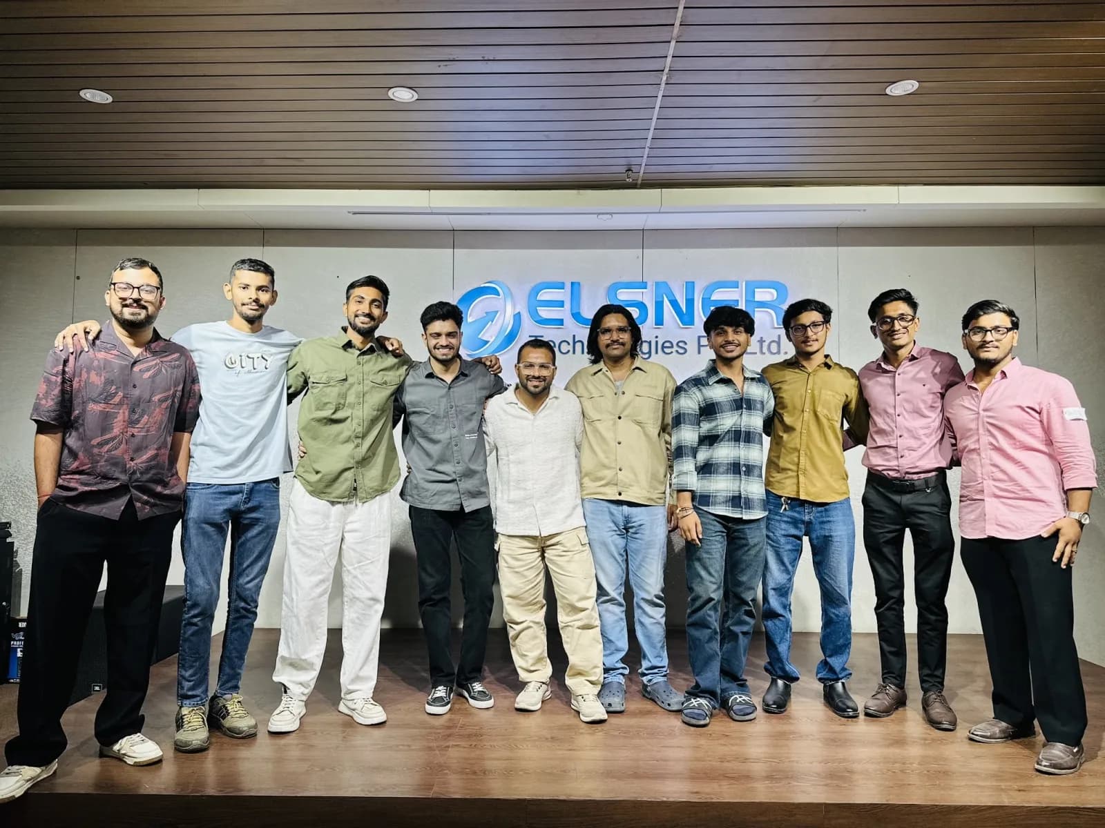Group photo of speakers and organisers on stage after the meetup